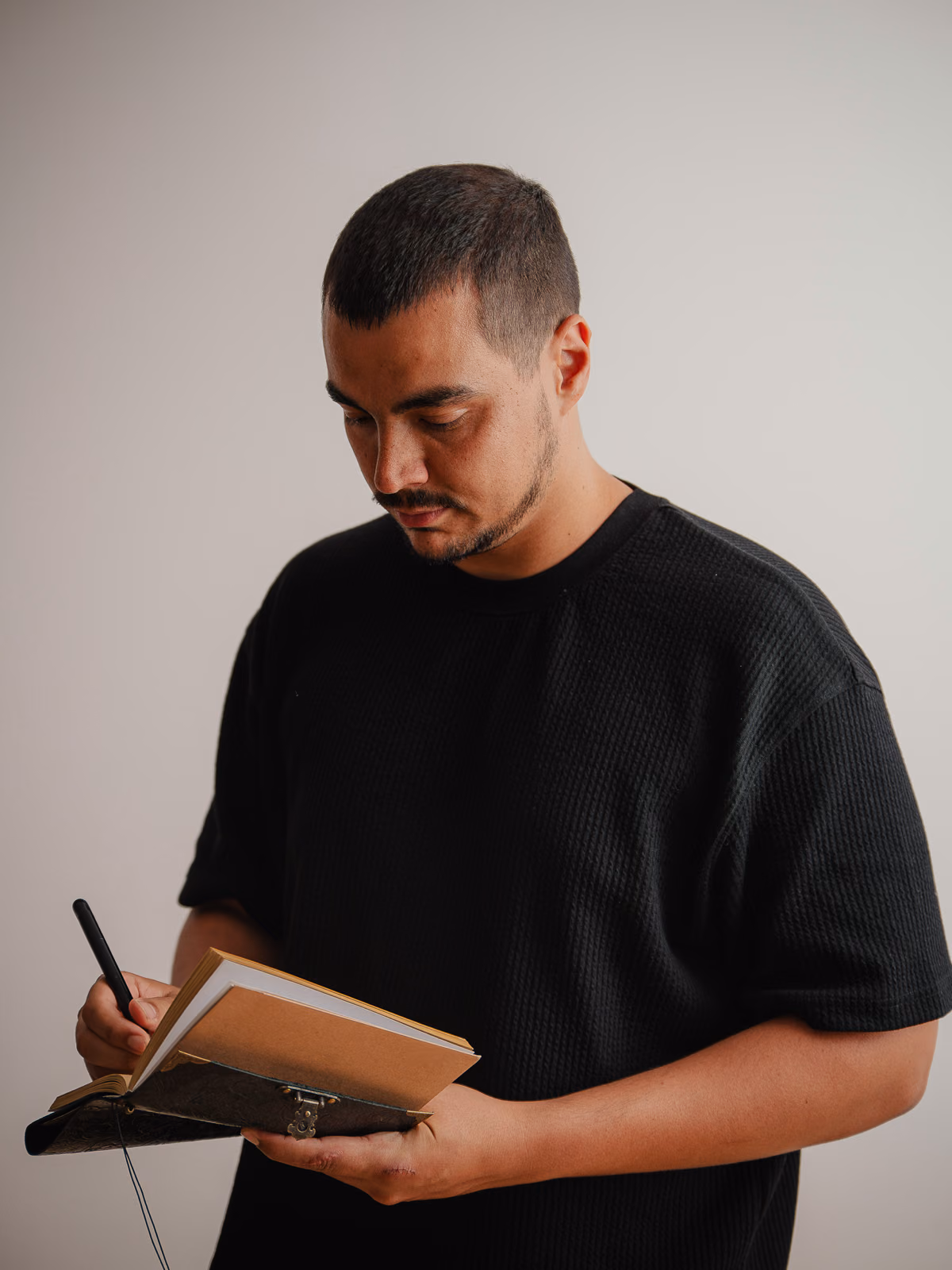 Sport psychologist Joaquin Gonzalez writing in his notebook during a personal brand portrait session, by Gorka Di Capitan
