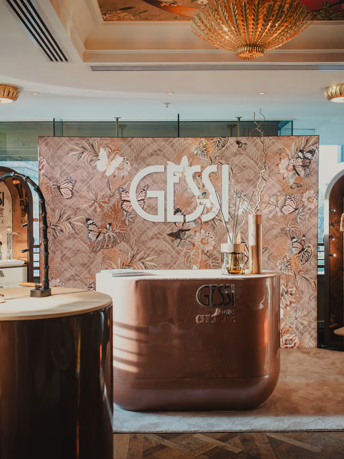 Gessi showcase stand with a copper basin in front of the brand's floral backdrop at The Ivy on the Square, Edinburgh