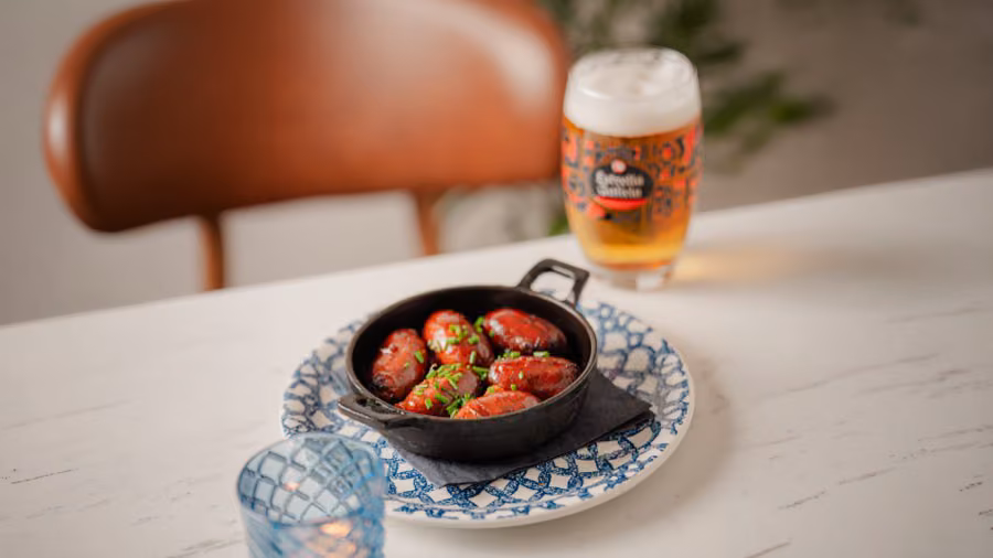 Skillet of blistered tomatoes with an Estrella Galicia at Tapas 3, Edinburgh